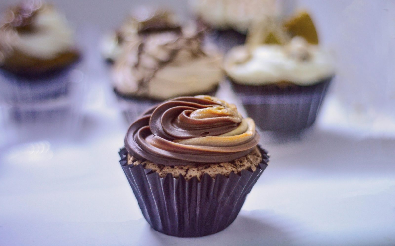 Close-up of chocolate cupcakes decorated with swirl frosting, creating a delightful treat.